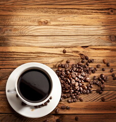 Cup of coffee. View from above on a wooden surface.