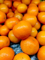 Ripe orange. Stacked citrus fruits are sold at supermarkets. Sweet fruits are fresh and healthy.