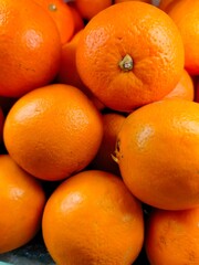 Ripe orange. Stacked citrus fruits are sold at supermarkets. Sweet fruits are fresh and healthy.