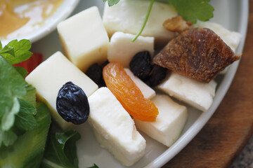 Cheese platter with dry food on a plate 