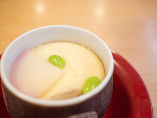 a cp of japanese steamed brothy custard at the conveyor belt sushi restaurant in japan