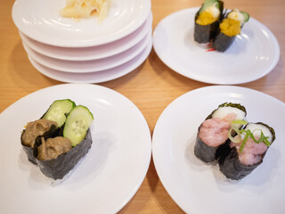 japanese traditional food sushi on the white plate at the conveyor belt sushi restaurant in japan