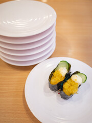 japanese traditional food sushi on the white plate at the conveyor belt sushi restaurant in japan