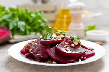Vegetarian salad with boiled beet, almond nuts and oil. Healthy food