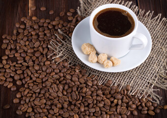 Coffee cup on a saucer and coffee grains