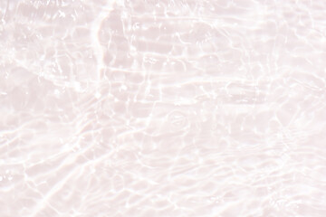 White water with ripples on the surface. Defocus blurred transparent white colored clear calm water surface texture with splashes and bubbles. Water waves with shining pattern texture background.