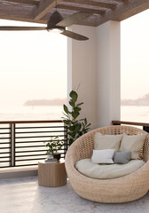 A cozy outdoor balcony lounge featuring a wicker lounge chair with pillows, and a nature view.