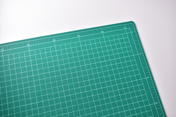 green cutting mat board on white background with line and scale measure guide pattern for object...
