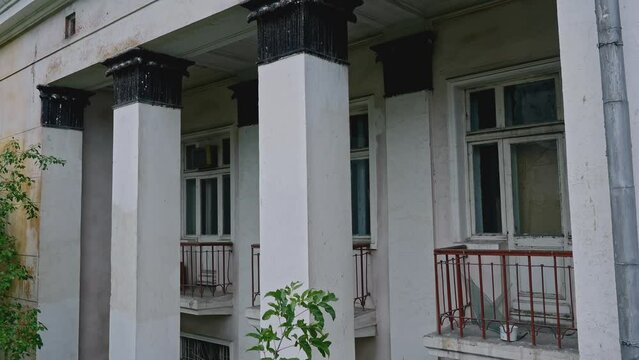 Abandoned 19th century palace with columns. Stock footage. Old manor house exterior.