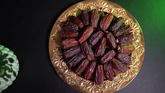 a plate with dates and a green plant