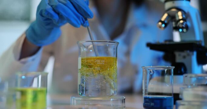 Chemical laboratory experiment. Measuring density of liquid oil and water