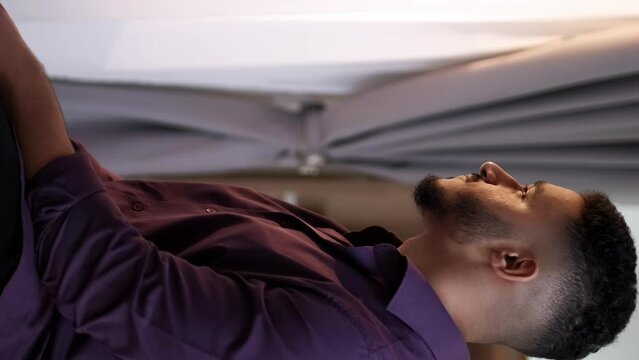 Vertical video. Morning inspiration. New day. Home leisure. Relaxed satisfied pensive guy enjoying drinking hot tea at window at light home interior with free space.