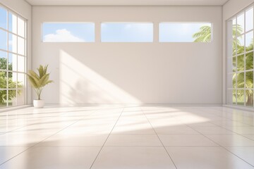 Fototapeta premium An empty room with white walls and large windows looking out onto a green landscape.