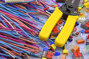 Tools for electrical work during the assembly of equipment. Close-up. Soft focus.