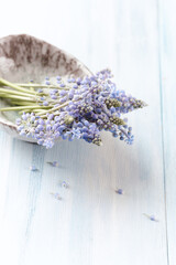 Purple flowers on bright wooden background. Close up. Copy space.	