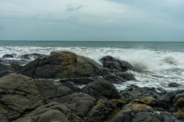 Image of a wave crashing on the rock