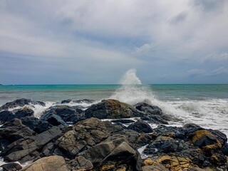 Image of a wave crashing on the rock