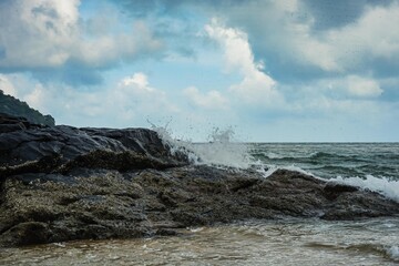 Image of a wave crashing on the rock