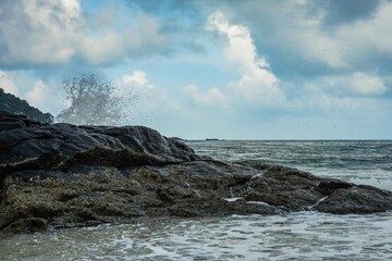 Image of a wave crashing on the rock