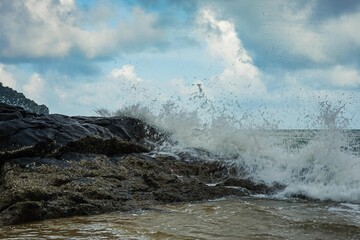 Image of a wave crashing on the rock