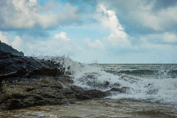 Image of a wave crashing on the rock