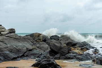 Image of a wave crashing on the rock