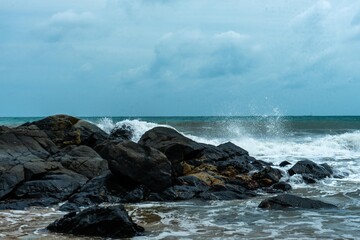 Image of a wave crashing on the rock