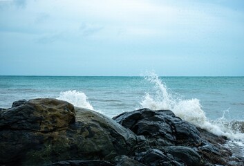 Image of a wave crashing on the rock