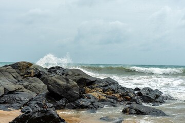Image of a wave crashing on the rock