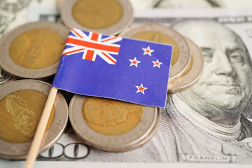 New Zealand flag on coin and banknote money, finance trading investment business currency concept.