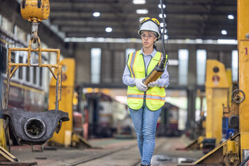 Maintenance engineer uses machine to lift and replace locomotive parts, reducing carbon emissions.