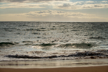 Summer sea background. Texture of water surface. Shining blue water ripple pattern.