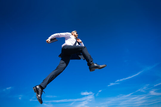 Businessman go jump and run. Next Steps. Business Ambitions concept. Goal business success strategy. Creative growth development. Growth business success process. Businessman running outdoor.