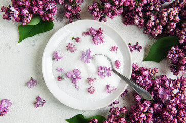 Bowl of Sugar With Lilac Blossoms on a Textured Background