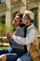 Two young multicultural girls sit on a bench, sharing a warm embrace as they express love and love towards each other.