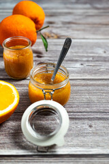 Delicious homemade orange jam in a glass jar. Healthy breakfast, vertical image for social media.