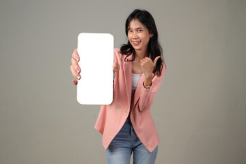 happy asian woman showing mobile phone screen with thumb up gesture on isolated background