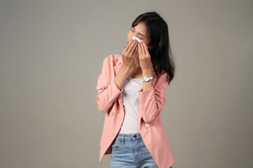 sad asian woman wipes her tears with tissue paper on isolated background