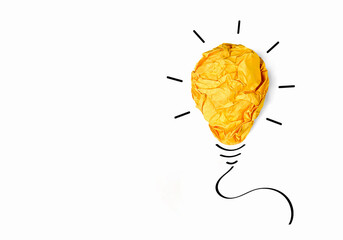 Creative ideas and Inspiration concepts. Crumpled colored paper in shape of yellow light bulb...