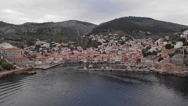 Marina And Port On Coast Of Hydra Island In Greece. aerial pullback shot