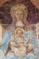 Obraz premium A mural fresco of Madonna with the child. Fresque murale de la Vierge Marie et l'enfant Jésus. Italie