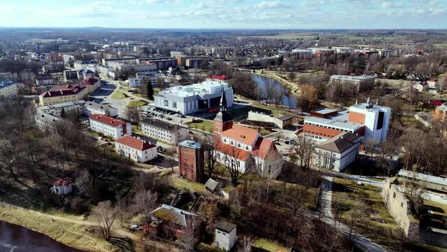 St. Simon's Church of Valmiera On Steep Bank Of Gauja River In Latvia. aerial shot