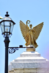 Obraz premium SAMUTPRAKAN, THAILAND - May 16, 2024: Statue of The Golden Angel Independence Monument at Assumption University, Suvarnabhumi Campus, Thailand.