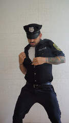 Man in policeman costume performing an striptease show