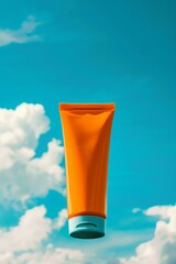 orange blank sunscreen tube blue sunny sky in the background
