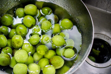 Green plum in a bowl