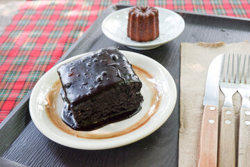 Homemade Canelés and Fudgy brownies on plate, traditional French sweet dessert,selective focus.