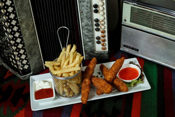 Plate of Crispy French Fries and Cup of Ketchup