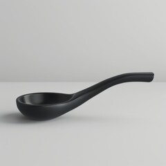 Black spoon placed on plain white background
