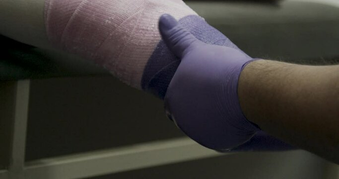 Doctor wrapping up amputated leg - close up